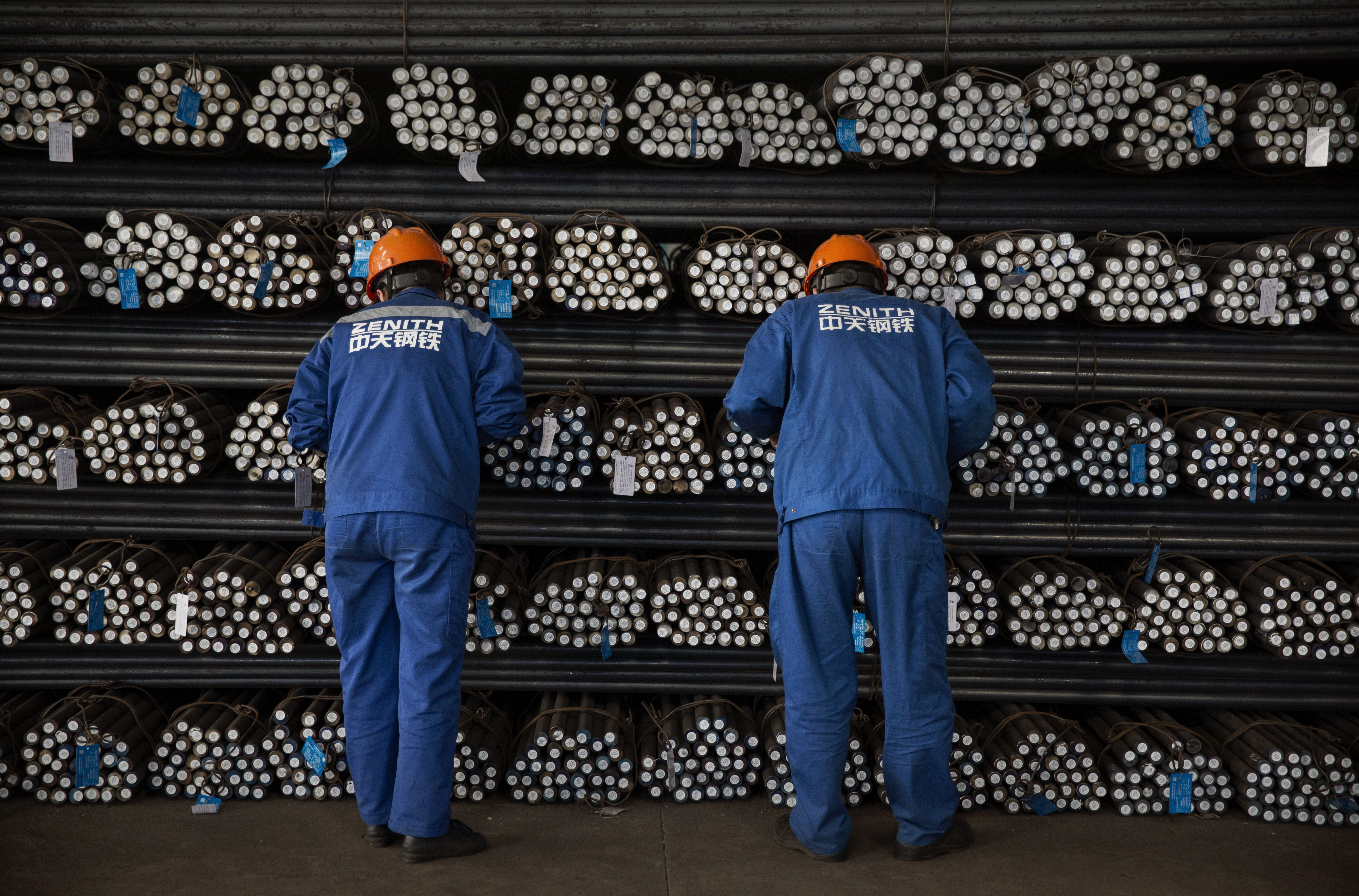 CHANGZHOU, CHINA - MAY 13: Workers inspect steel bars for quality in the production area of the Zhong Tian (Zenith) Steel Group Corporation on May 13, 2016 in Changzhou, Jiangsu. Zhong Tian (Zenith) Steel Group Corporation is a privately-owned manufacturer that employs over 13,000 workers at its facility in China's eastern Jiangsu province. Since 2001,the company says it has adopted new technology to streamline the production of premium quality steel and to reduce environmental impact. The majority of its steel output is for the Chinese market with 20% earmarked for export, mostly to Asia. The company says it is profitable, but admits business has dropped marginally from past years. China is the world's largest steel producer, accounting for over 50% of global supply. China's government has vowed to cut production capacity at state-owned enterprises by up to 150 million tonnes over five years to ease concerns of an oversupply on global markets. However, its efforts appear to be overshadowed by a recent increase in steel prices that has revived production at some Chinese facilities that had been closed down. (Photo by Kevin Frayer/Getty Images)
